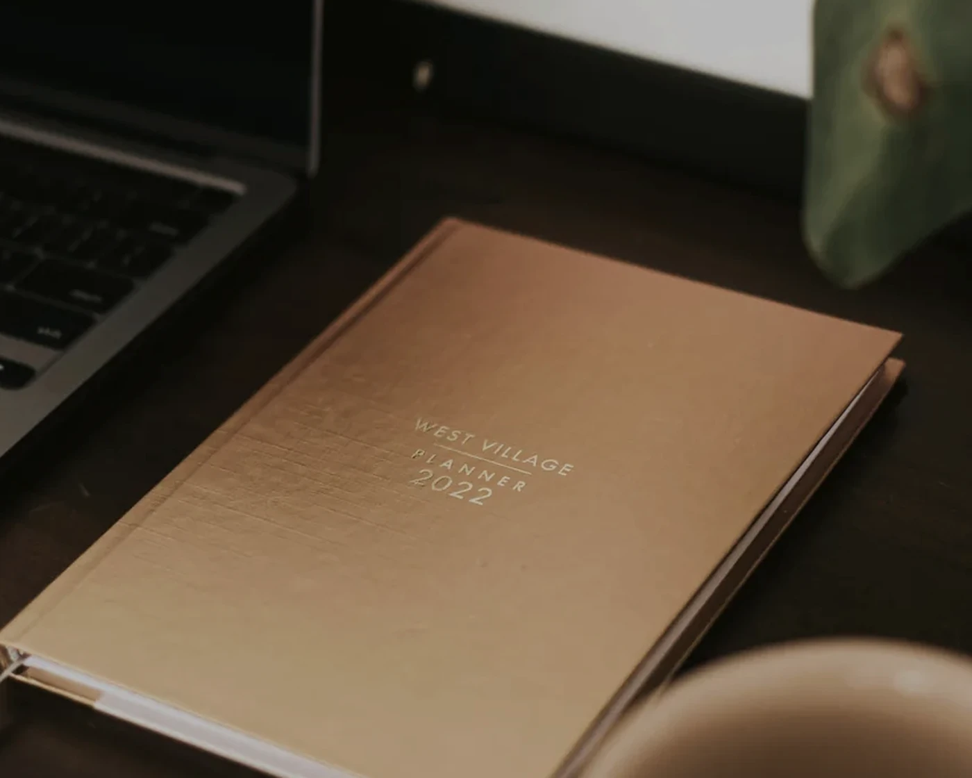 Luxury planning desk with notebook and coffee suggesting organized travel planning.