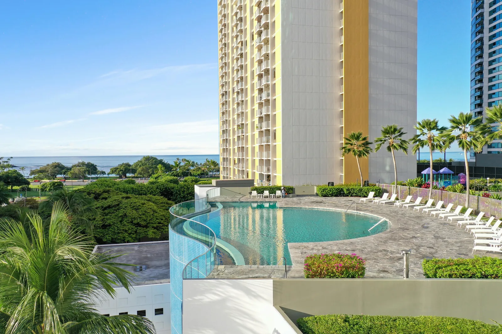 Luxury hotel pool with tropical landscaping.